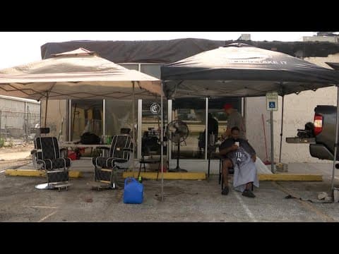 His barber shop was destroyed in the derecho so he started cutting hair in the parking lot