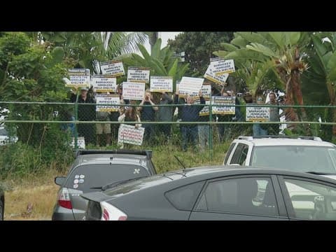 Protestors shout at Mayor Todd Gloria during news conference about plans to open a mega-shelter and