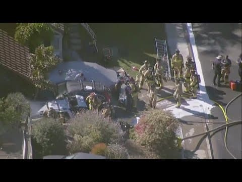 Ten men work to help save man from burning car