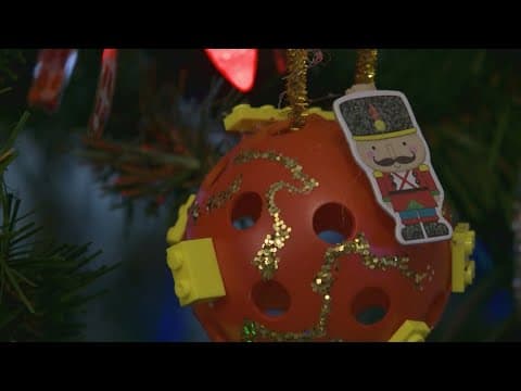Woman turning cracked pickleballs into Christmas tree ornaments