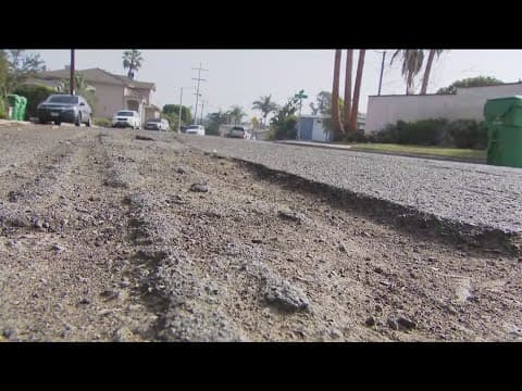 What's being done to fix the potholes and corroding asphalt in this Loma Portal neighborhood?