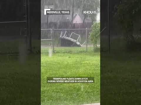 Trampoline floats down ditch during severe weather in Houston area #shorts
