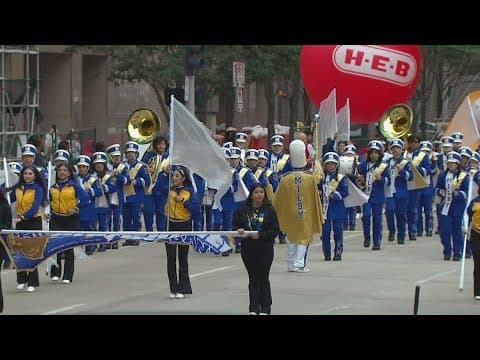 Milby High School band marches through the H-E-B Thanksgiving Day parade