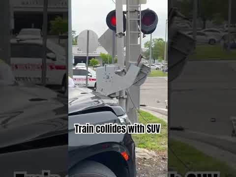 Amtrak passenger train collides with a Chevy SUV sitting at railroad crossing.