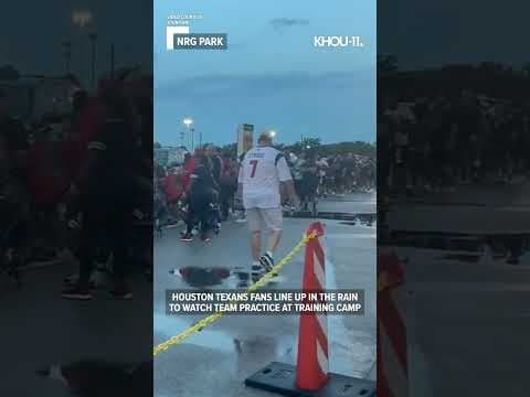 Houston Texans fans brave the weather and line up to see the team practice at training camp