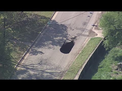 Truck gets stuck in apparent sinkhole in Dallas road