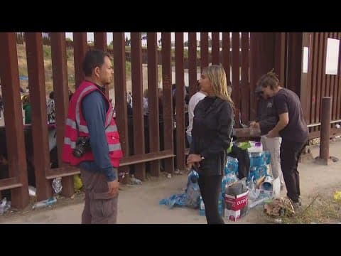 Migrants prepare for what asylum may look like from in between the U.S.-Mexico border wall