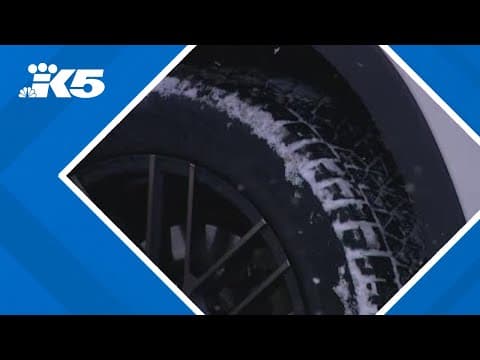 Drivers navigate snowy roads at Snoqualmie Pass