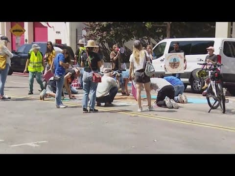 Climate activists demonstrate outside Sempra Energy headquarters in Downtown San Diego