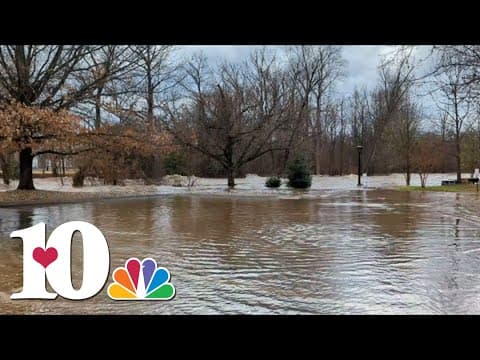 Little Pigeon River swells in Pigeon Forge behind Christmas Place, flooding parking lot