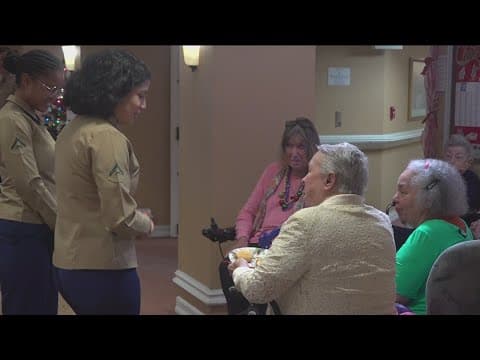 Active duty Marines spread Christmas cheer to veterans in assisted living home