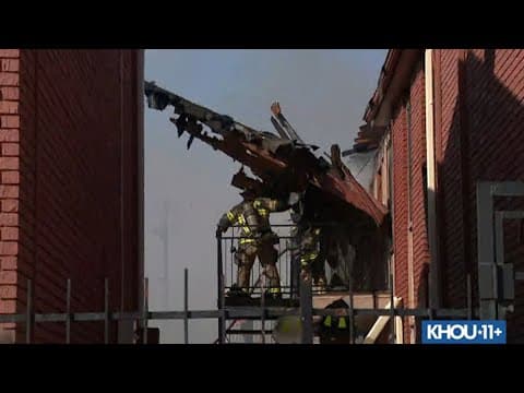 Wall collapses onto Houston firefighters battling massive apartment fire