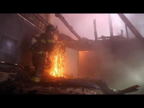 Firefighters rescue elderly woman from Indianapolis house fire minutes before roof collapse