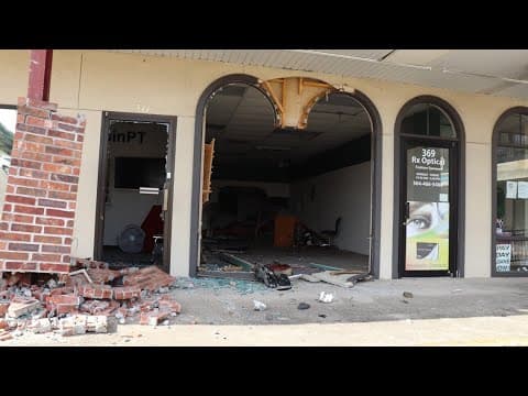 Out of control car slams into office buildings