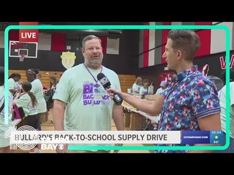 Volunteers stuff thousands of backpacks to donate to students during back-to-school supply drive