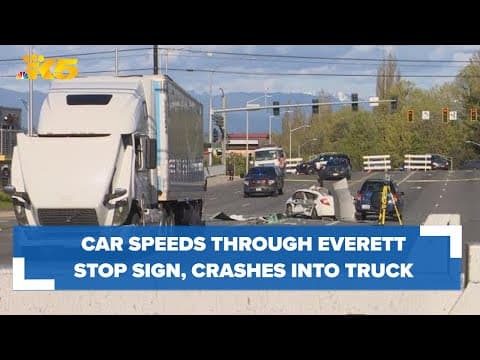 Car speeds through stop sign, crashes into semi-truck in Everett