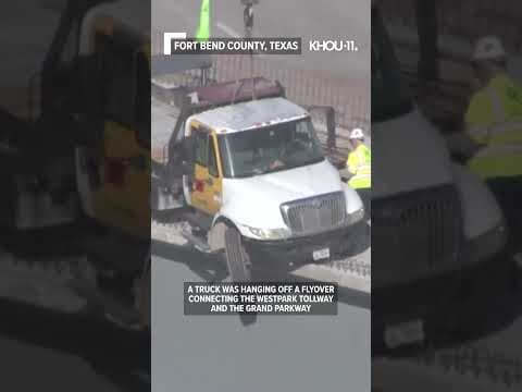 Truck hangs off flyover in Houston area, debris hits car below
