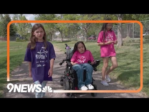 Group of girls work together to make sure everyone crosses finish line at 5K race in Colorado