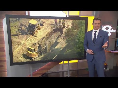 Construction crews work to repair the giant sinkhole that trapped a truck and trailer