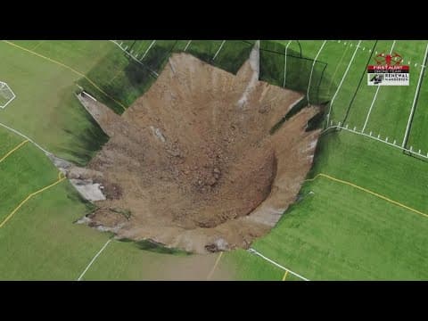 Surveillance video shows the moment when a 100-feet-wide sinkhole swallows a soccer field
