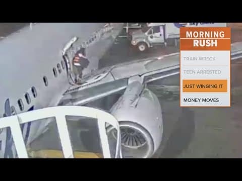 Video shows a woman opening a plane door and exiting onto the wing
