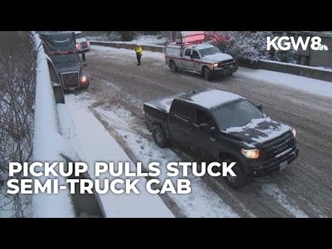 Raw video: Good Samaritan pulls semi-truck cab off snowy ramp in Portland
