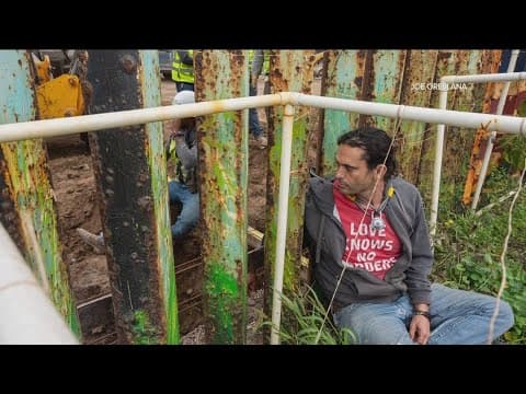 Protestors chain themselves to U.S.-Mexico border wall