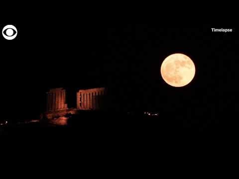 Timelapse shows strawberry supermoon rising over ancient temple in Greece