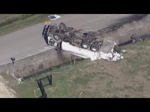 Garbage truck driver critically injured after garbage truck flips over in Crosby