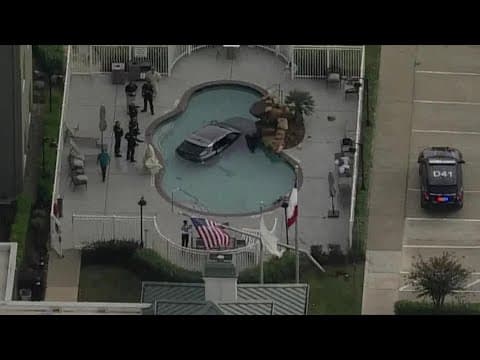 Vehicles submerged in west Houston hotel pool
