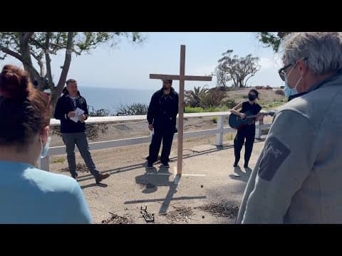 Members of burned LA church bear a cross through their devastated neighborhood to mark Good Friday