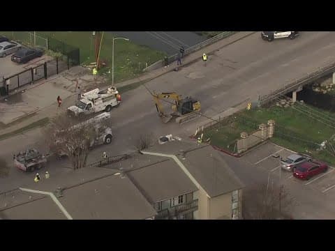 Vehicles damaged after excavator hit power lines, snapping at least 2 poles in Houston