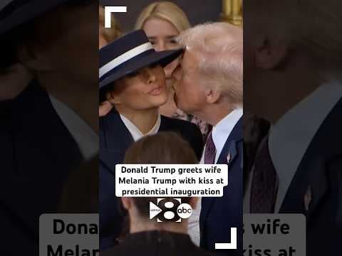 President Donald Trump gives wife, First Lady Melania Trump, a kiss at inauguration