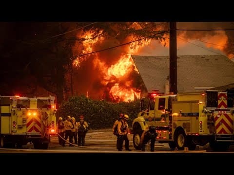 Firefighters battle devastating Los Angeles wildfires as winds calm somewhat