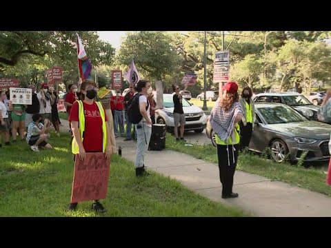 Demonstrators and Trump supporters await former President Trump's arrival