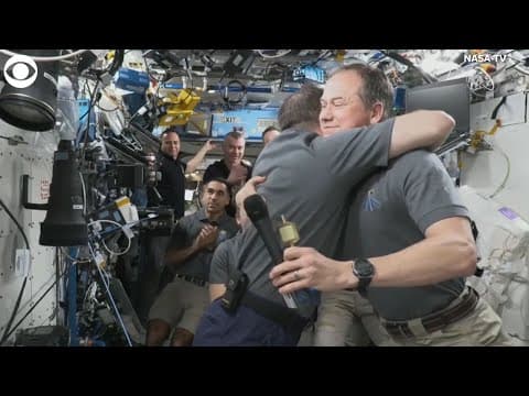 Russian cosmonaut, NASA astronaut hug during change of command ceremony on ISS