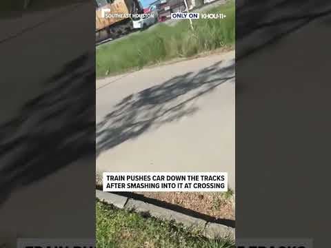 Train pushes car down the tracks after smashing into it at crossing #shorts