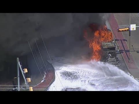 Tanker carrying 5,000 gallons of diesel fuel up in smoke as firefighters battle the blaze