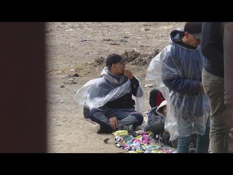 Migrants gathered at US-Mexico border plead for food and water