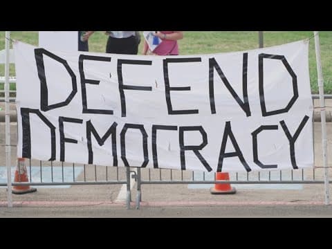 Protesters demonstrate outside an ICE job fair in Arlington