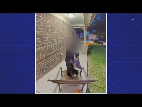 Young trick-or-treater replenishes empty candy bowl in Atascocita