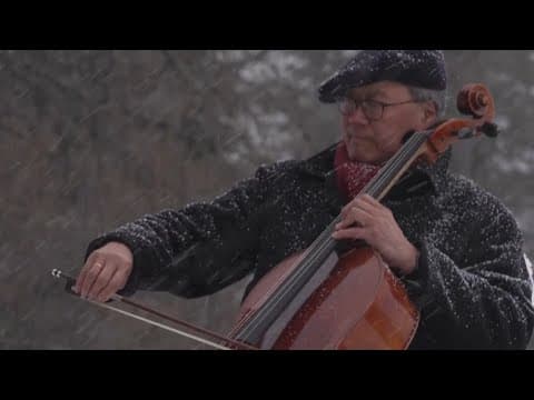 Cellist Yo-Yo Ma performs on snowy mountainside above World Economic Forum in Davos