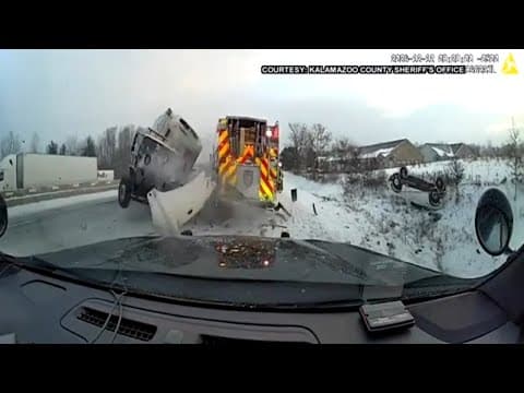 Truck crashes into emergency vehicles in Michigan