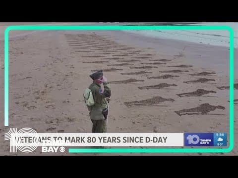 Silhouettes of 80 soldiers etched onto the beach in Normandy