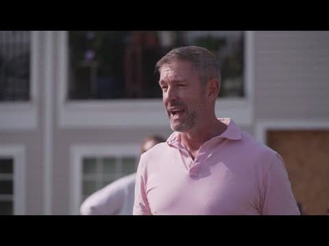 Councilman Chad West helps install temporary barriers at Dallas traffic circle