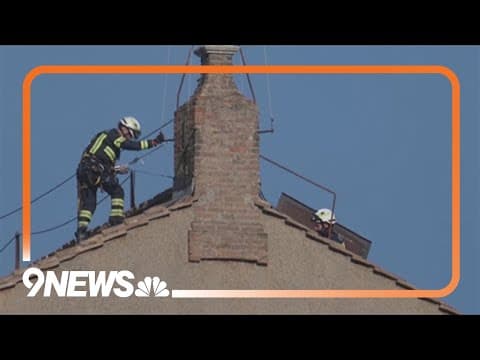 Vatican firefighters install a chimney on the roof of the Sistine Chapel for the papal election
