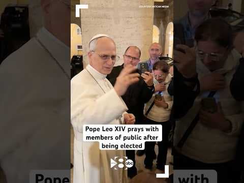 Pope Leo XIV prays with members of public after being elected
