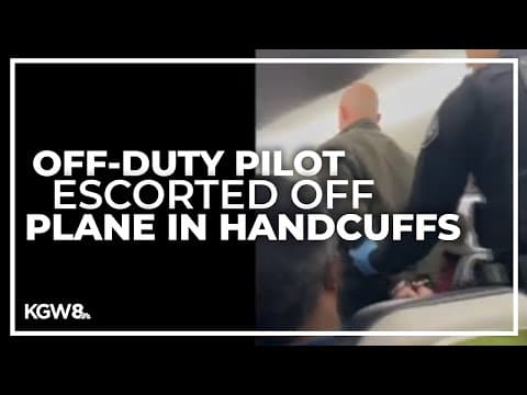 New video shows pilot escorted off flight in handcuffs; attorney says he wasn't intoxicated
