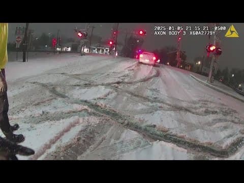 VIDEO: Car stuck in the snow almost hit by train