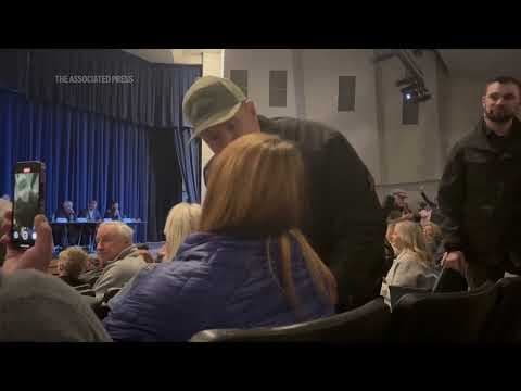 Idaho town hall meeting turns chaotic after woman is forcibly removed for shouting at speakers